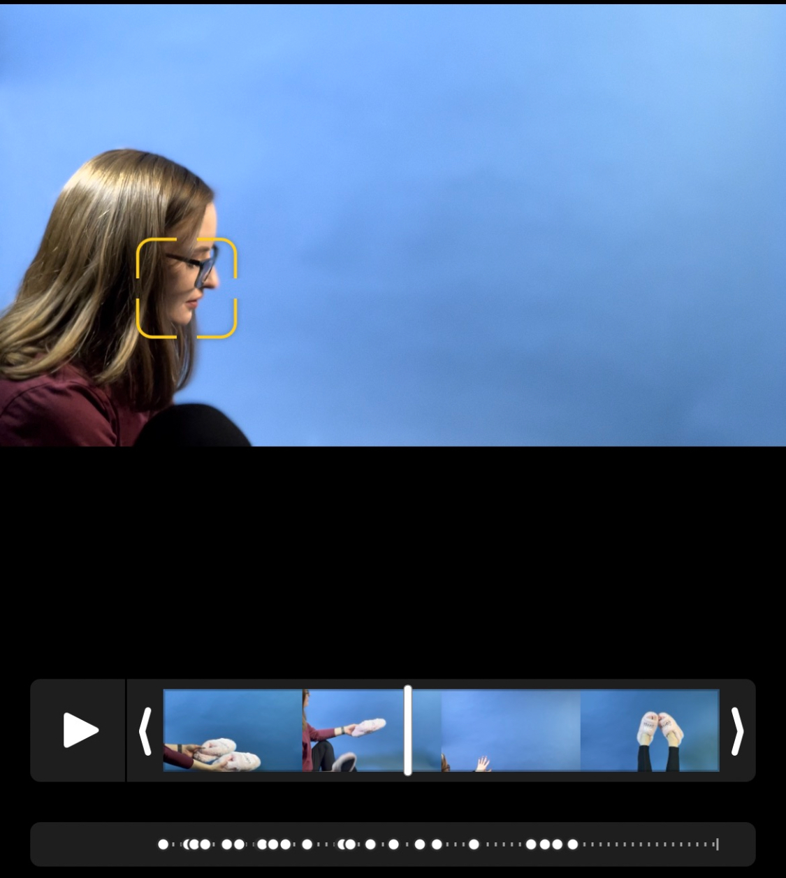 Amanda in profile against a blue backdrop